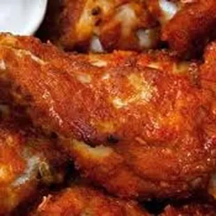 a plate of buffalo wings with ranch dip