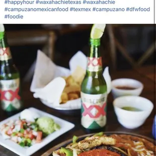 a plate of food and a bottle of beer