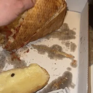 a person taking a slice of pizza