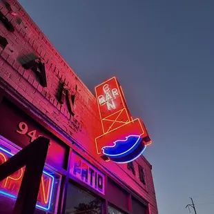 a neon sign on the side of a building