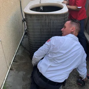 our team removing an old system replacing it with a new 16 seer efficient system