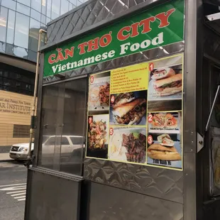 a vietnamese food stand on a city street