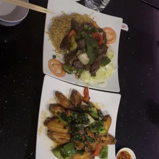 two plates of food with chopsticks