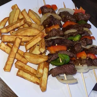 kebab and fries on a white plate