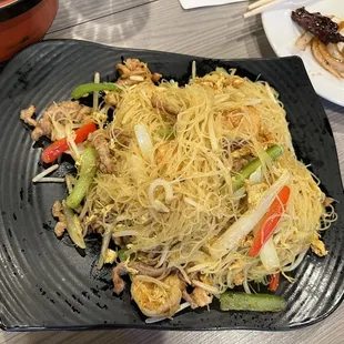 a plate of noodles with meat and vegetables