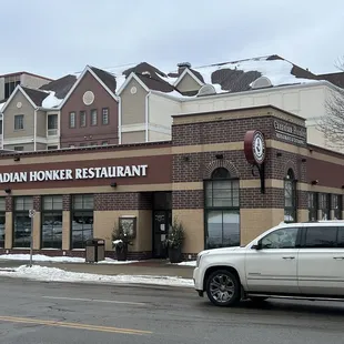 a car parked in front of a restaurant