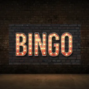 a brick wall with the word bingo lit up