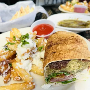 Falafel sandwich with garlic feta fries several al Fresca by the canal