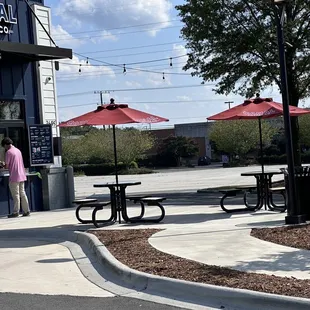 a man standing in front of a coffee shop