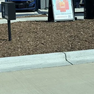 a sign in front of a coffee shop