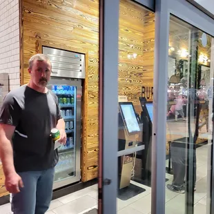 a man standing in front of a vending machine