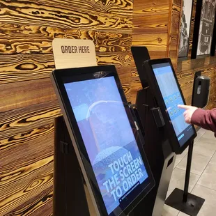 a woman pointing at a menu