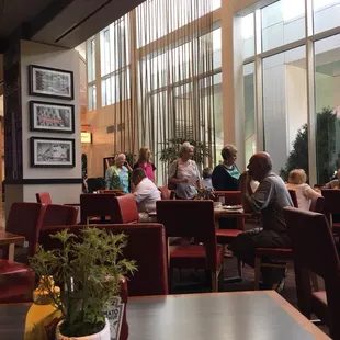people sitting at tables in a restaurant