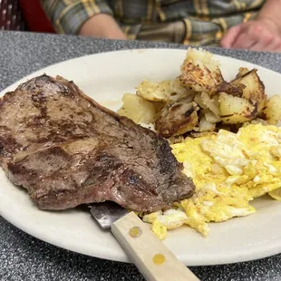 a steak and eggs on a plate