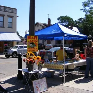 a woman selling fruit and vegetables
