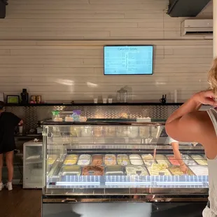 a woman standing in front of a counter