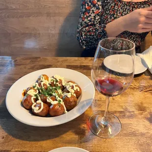 a plate of food and a glass of wine