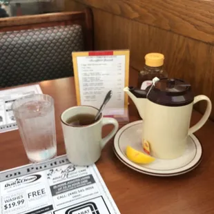 a cup of coffee and a teapot