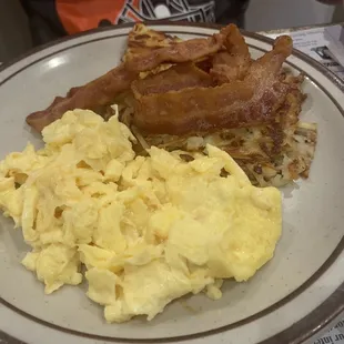 a plate of scrambled eggs and bacon