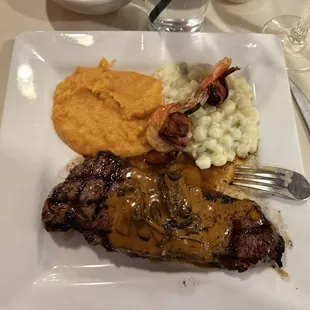 NY Strip with mushroom sauce hominy and  sweet potatoes with two bacon wrapped shrimp.  Was the nights special.