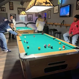 Two pool tables in back.