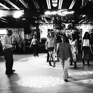 a black and white photo of people dancing