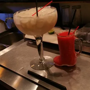 a margarita and a drink on a counter