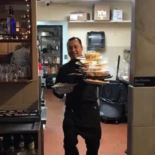 a man carrying a tray of food