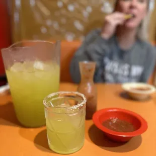 Pitcher of lime margaritas on the rocks and salsa