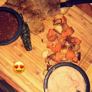 a wooden cutting board with a variety of food items