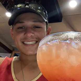 a man holding a margarita