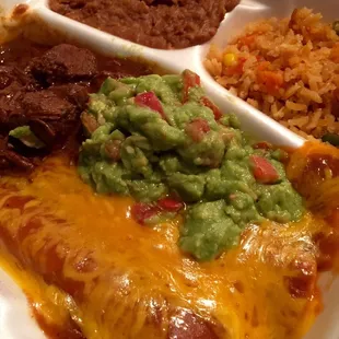 Texas Plate. Cheese enchiladas, carne guisada, and guacamole