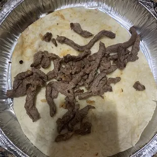 The inside of what should be a carne Asada burrito.