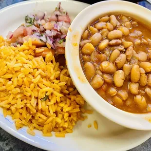 Side of rice with pico de gallo &amp; charro beans that go with the &apos;Molcajete&apos; plate
