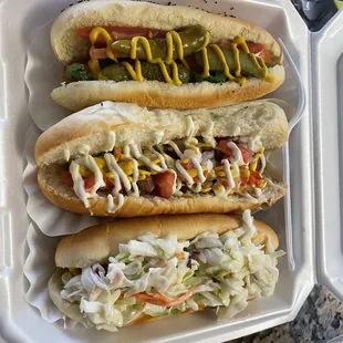 two hotdogs in a styrofoam container