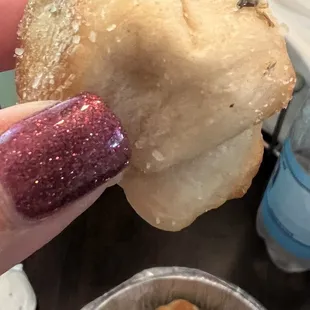 a hand holding a pastry