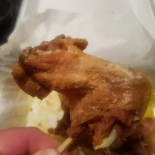 Is it a chicken wing? Not sure, but the protruding bones make it easy to pickup. And the person cooking the wings didn't see this?