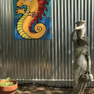 a statue of a woman holding a jug