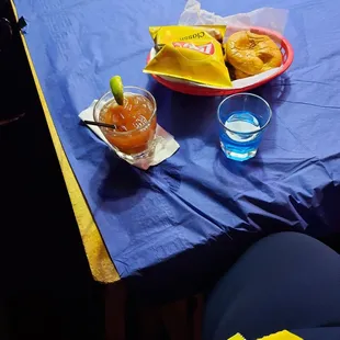 a table with a blue tablecloth and a plate of food