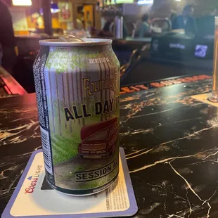 a can of beer on a coaster