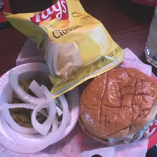 Burgers come with chips, pickles, jalapeños, raw onions.