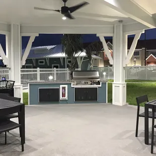 Grilling areas with pool behind it