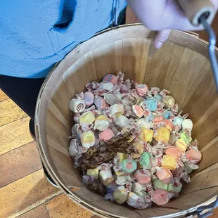 a person holding a basket of candy