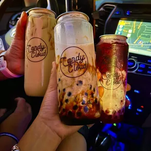 a hand holding two drinks
