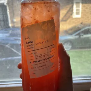 a hand holding a jar of jelly
