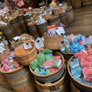 a variety of candys in wooden buckets