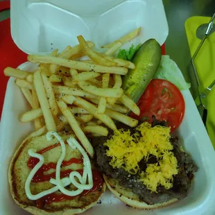 a hamburger and fries in a styrofoam container