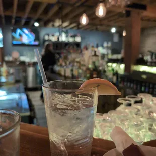 a glass of water with a slice of lemon