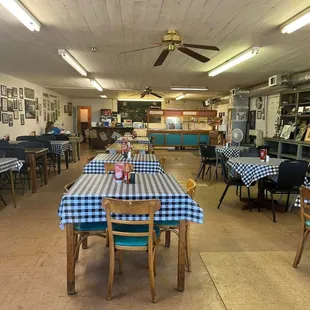 tables and chairs with blue and white checkered tablecloths