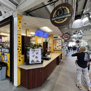 a woman standing in front of a counter